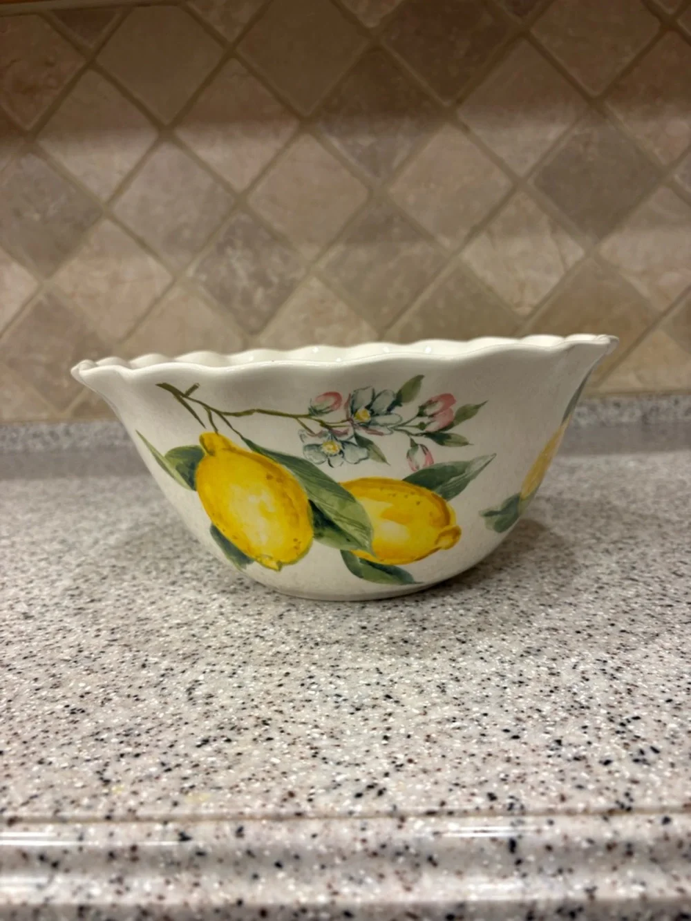 Hand-painted ceramic ruffle bowl featuring lemon motifs. Never Used. Display